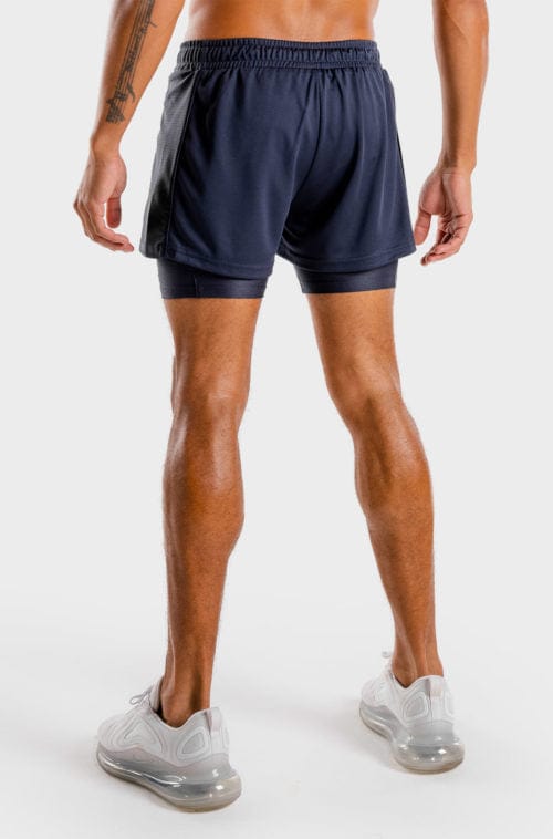 Íþróttaföt frá Squat Wolf í vefverslun Ludus.is. Æfingafatnaður - Hybrid 2 in 1 shorts eru flottar stuttbuxur fyrir herra. Þessar bláu stuttbuxur henta jafnt í Crossfit sem hlaup. #litur-color_navy